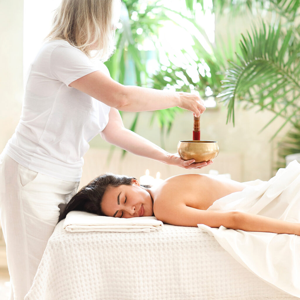 Masseuse providing a massage to a client in a tranquil setting, symbolizing holistic health and wellness.