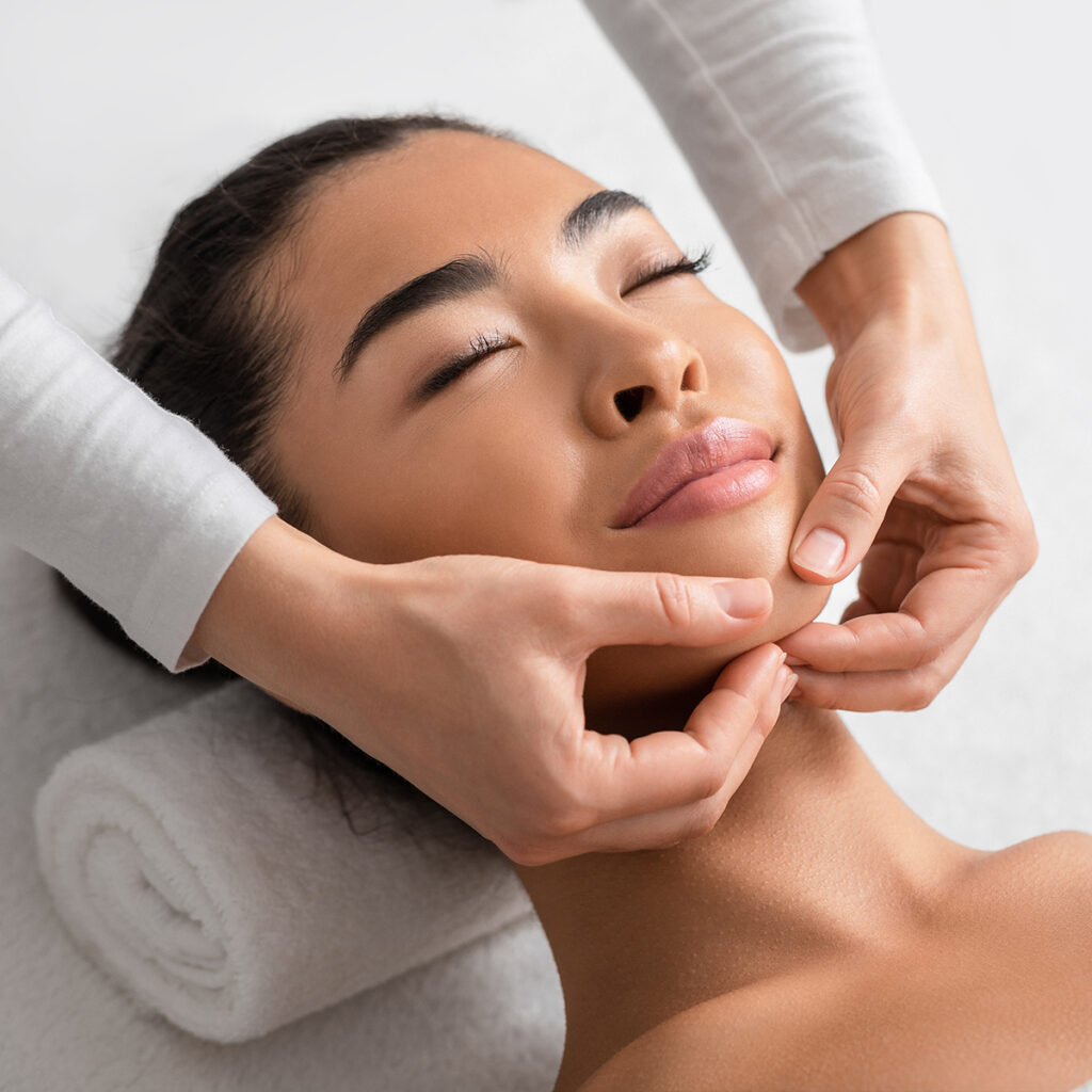 Woman receiving a custom skin care facial treatment.