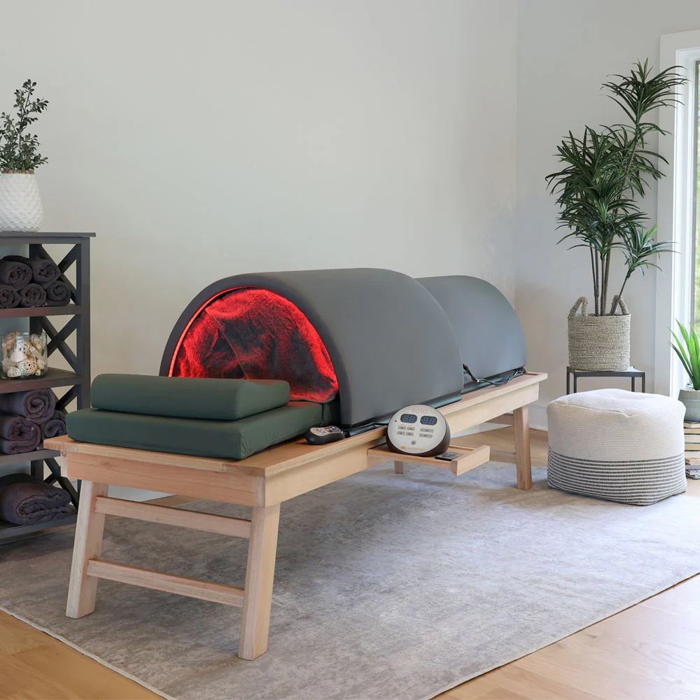 A cozy spa room featuring a Solo System Sauna bed, designed for relaxing and therapeutic spa services.