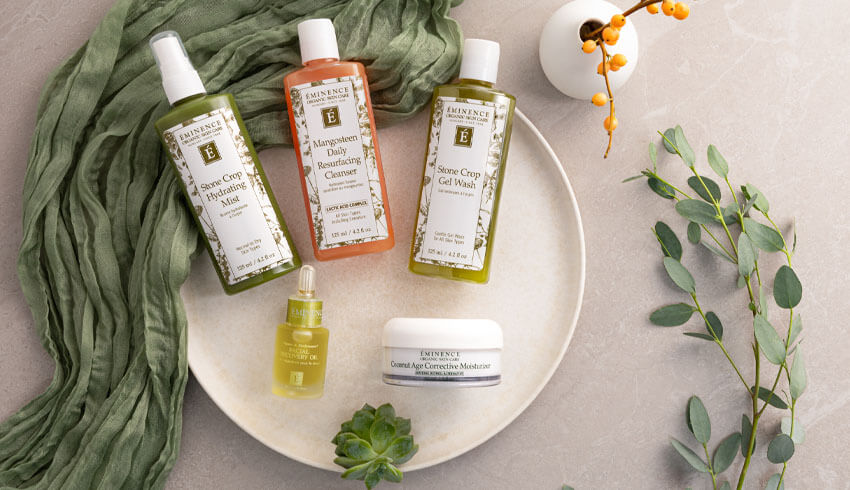 Eminence Organic Skin Care laying on a tray with leaves