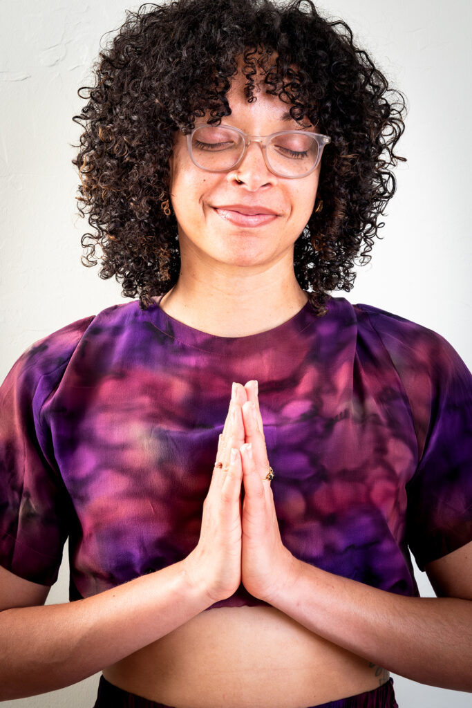 Peaceful yoga practitioner with hands in prayer reflecting holistic health