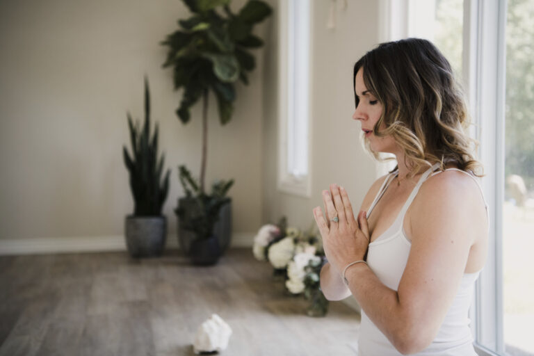 Woman in peaceful meditation posture during a mindful reset practice.