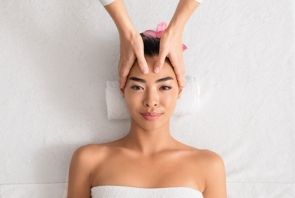 Woman receiving Japanese Head Spa treatment, embracing sacred stillness at The Yoga Spa